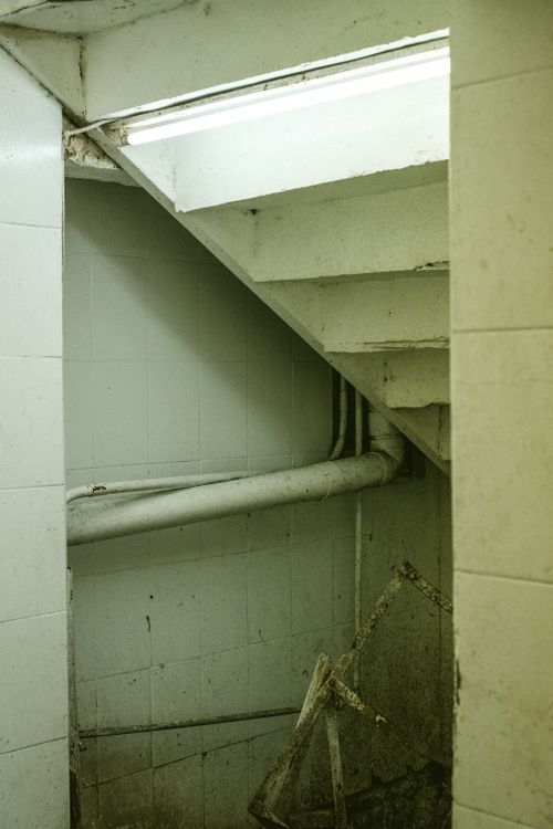 Free A neglected stairwell with peeling paint and dim lighting, ideal for urban exploration themes. Stock Photo