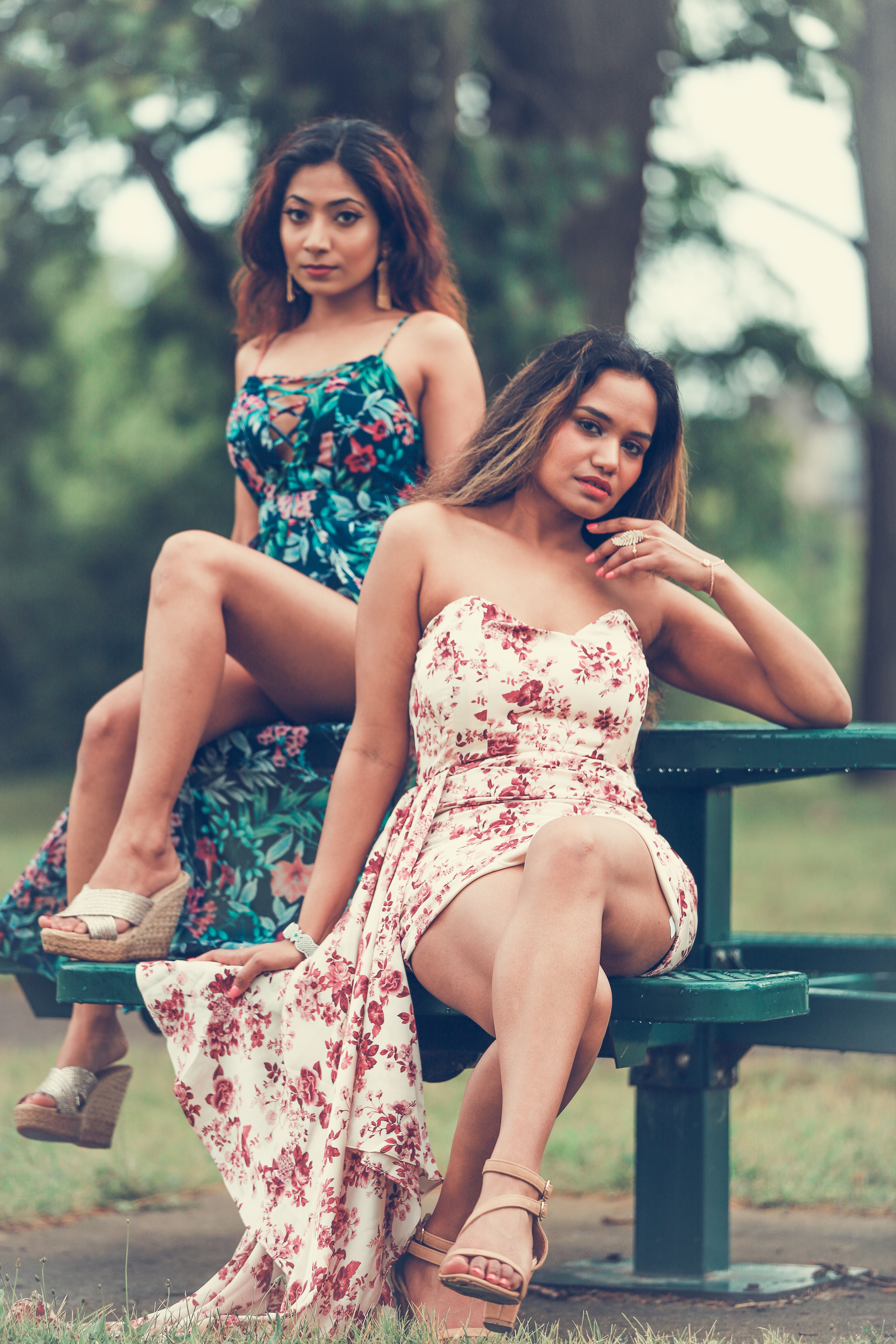 Elegant Women in Floral Dresses Posing Outdoors · Free Stock Photo