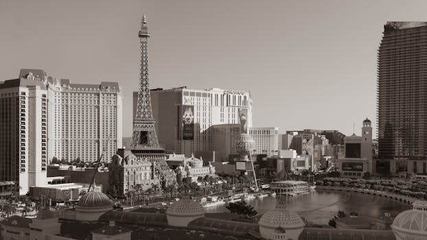 Black and white photo of Las Vegas Strip featuring the Eiffel Tower replica and surrounding hotels.