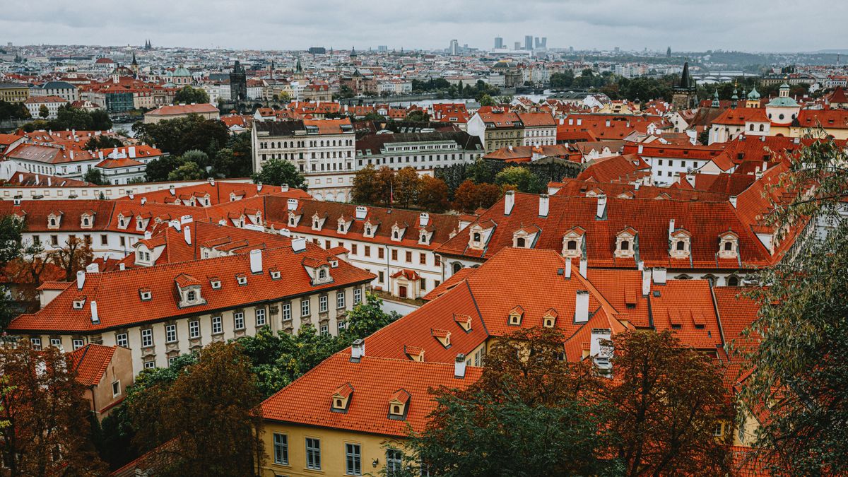 Aerial view of historic Prague showing red rooftops and church spires