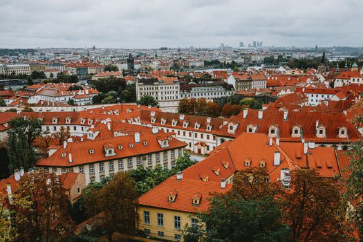 Explore the stunning red tiled rooftops of Prague, captured from above, offering a picturesque urban landscape.