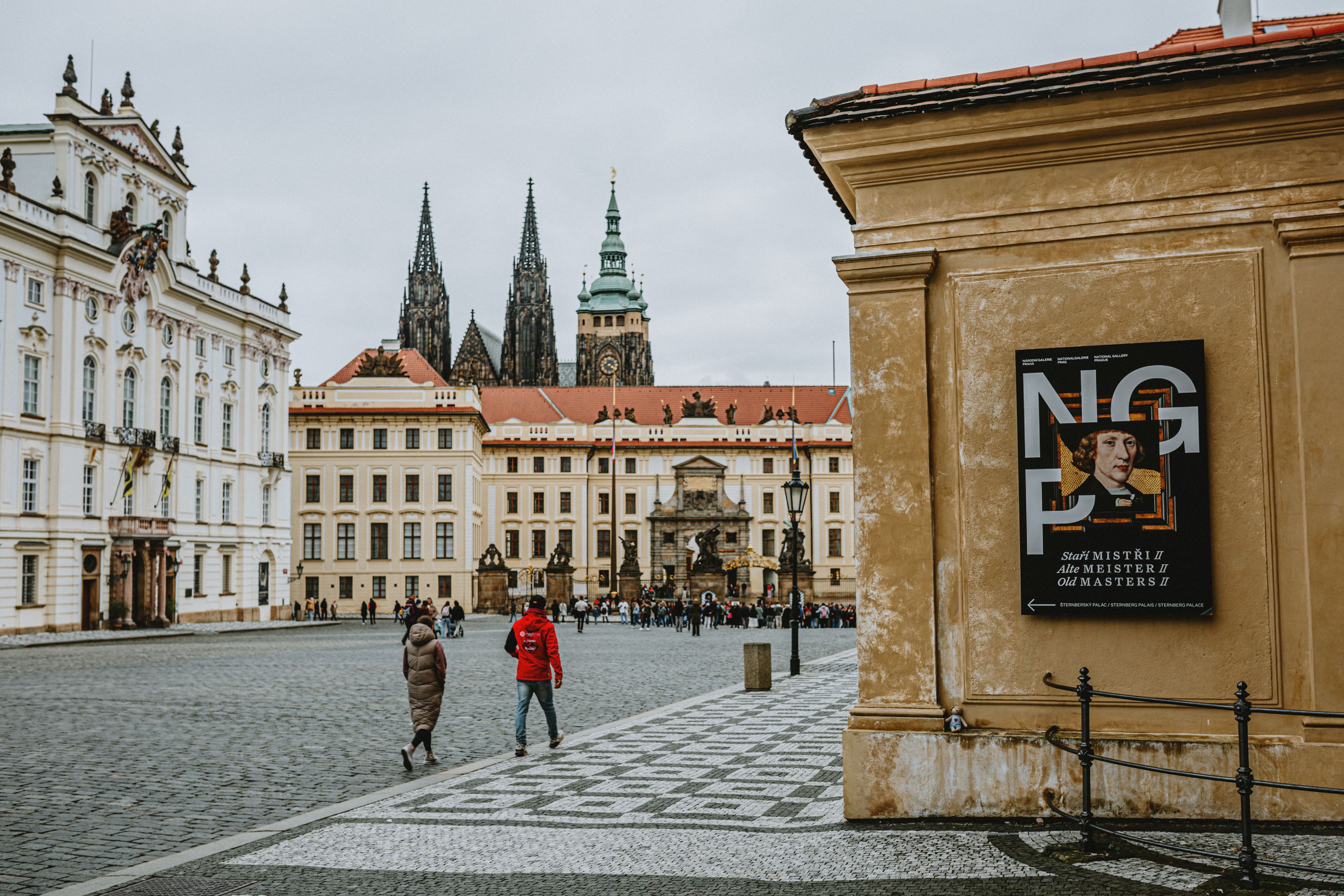 Historic architecture of Prague Castle and Saint Vitus Cathedral under a cloudy sky.