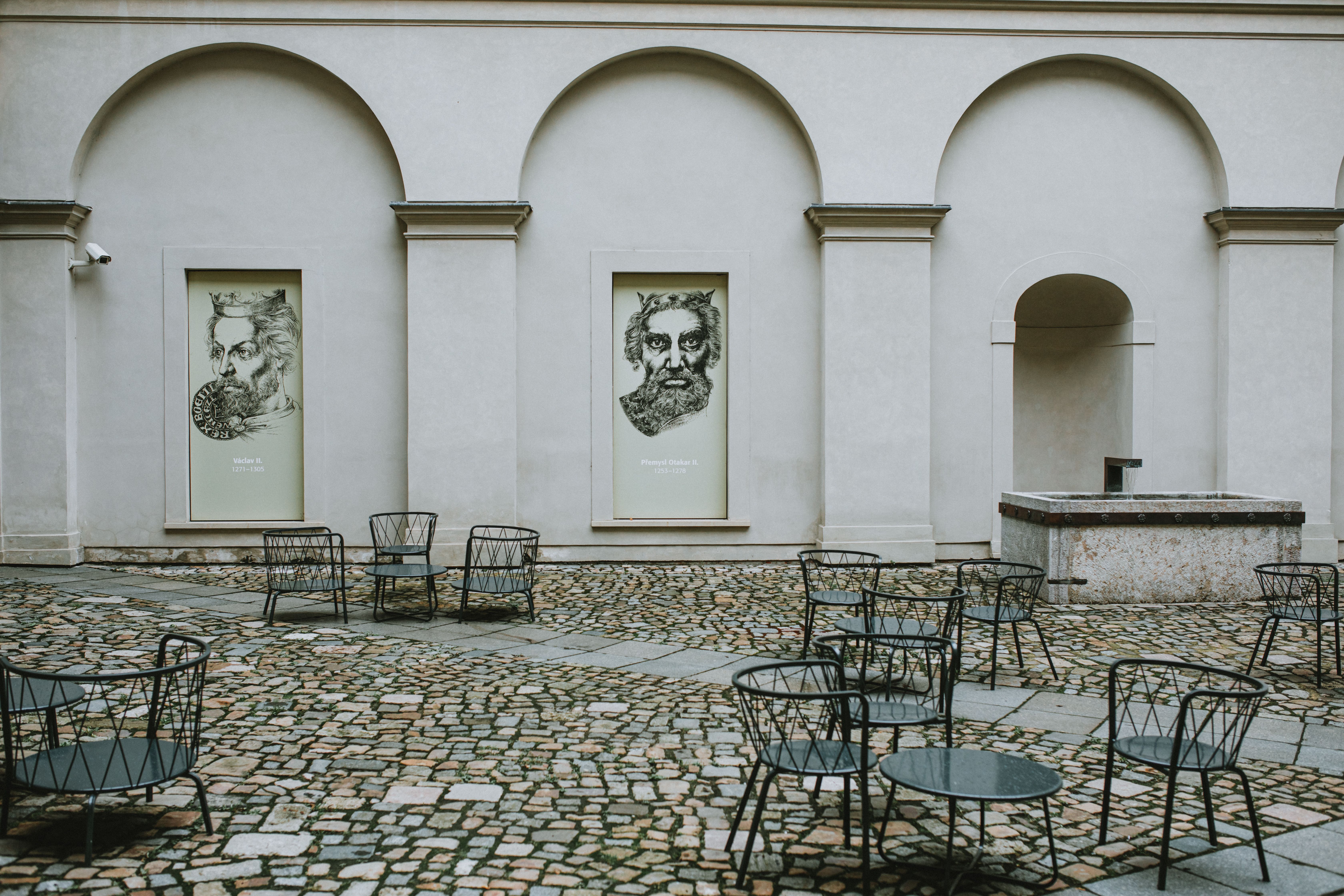 Guests entering an elegant contemporary art exhibition in a historic European gallery