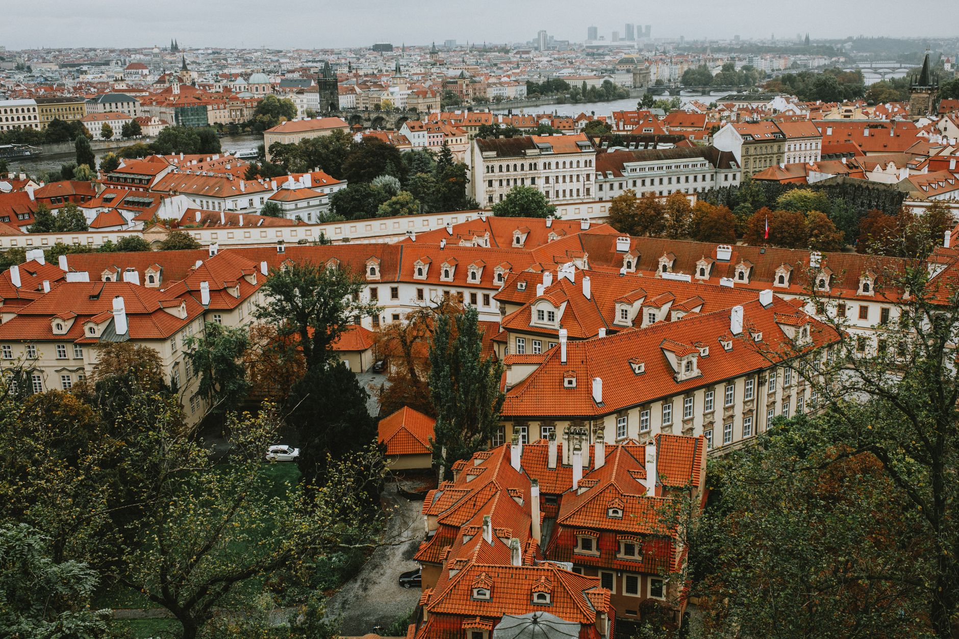 A stunning aerial view of Prague showcasing iconic red roofs and historical architecture.