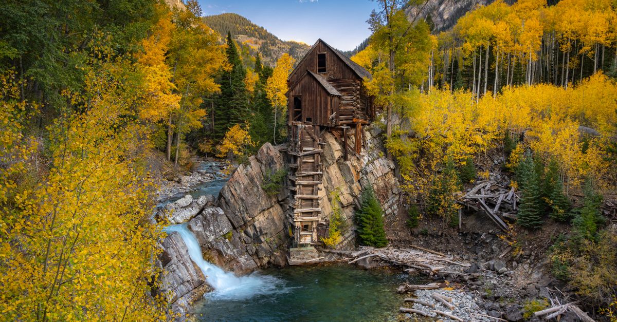 A picturesque view of the historic Crystal Mill surrounded by vibrant fall colors in Carbondale, Colorado.