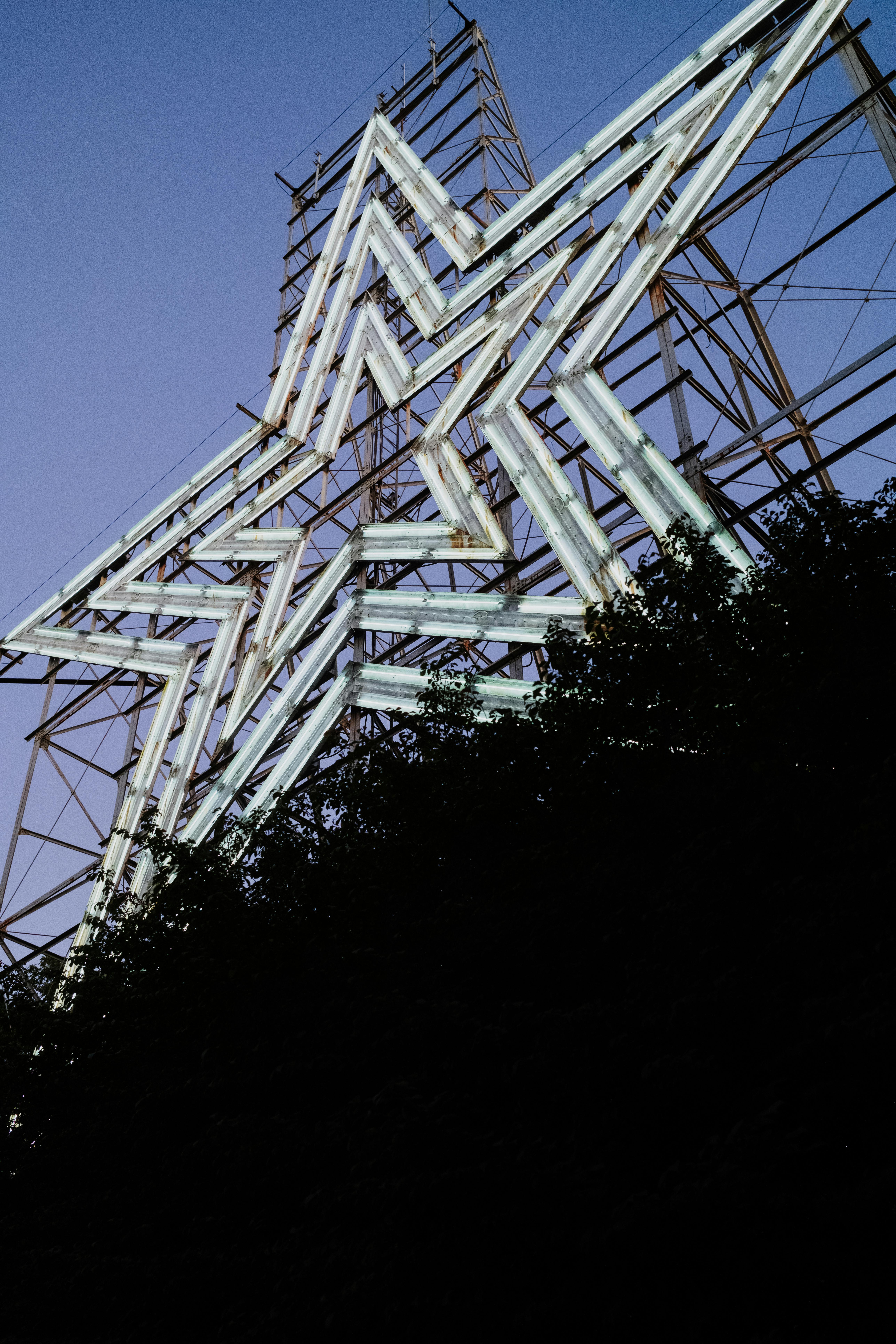 Discover the illuminated Roanoke Star glowing against a twilight sky at Mill Mountain, Virginia.