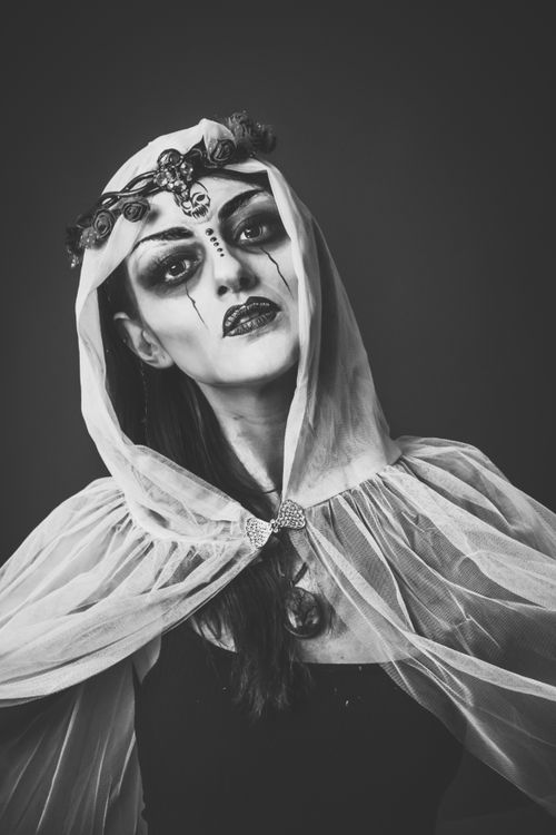 Free Dramatic black and white portrait of a woman in gothic Halloween costume with artistic makeup. Stock Photo