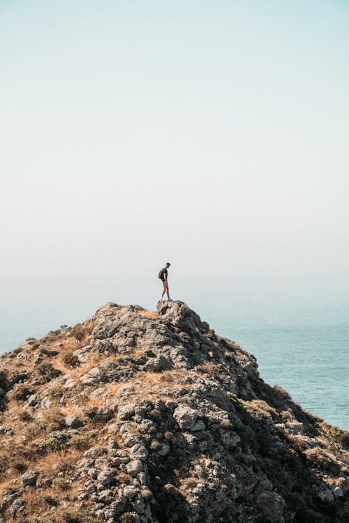 Man Standing on Rock Hill