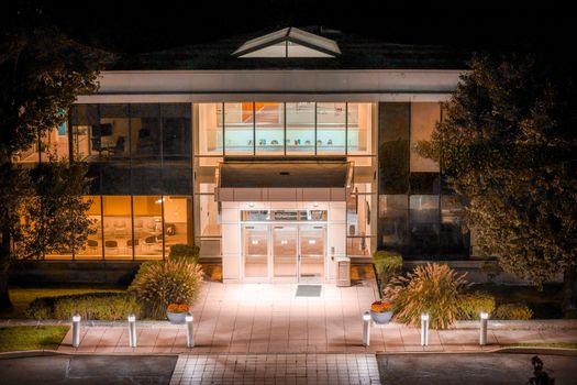 Illuminated modern office building facade in Stamford, Connecticut at night.