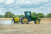 Green and Yellow Tractor on Dirt