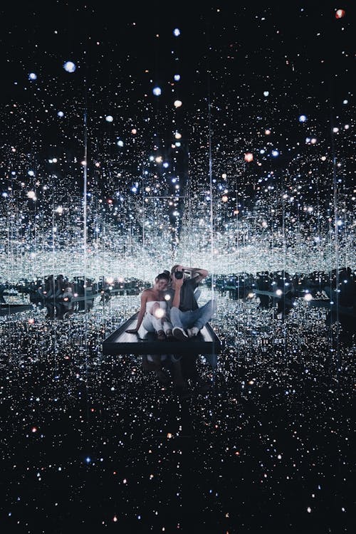 Couple Sitting on Concrete Dock