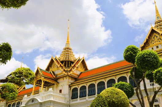Stunning view of the ornate Grand Palace in Bangkok under the bright summer sky.