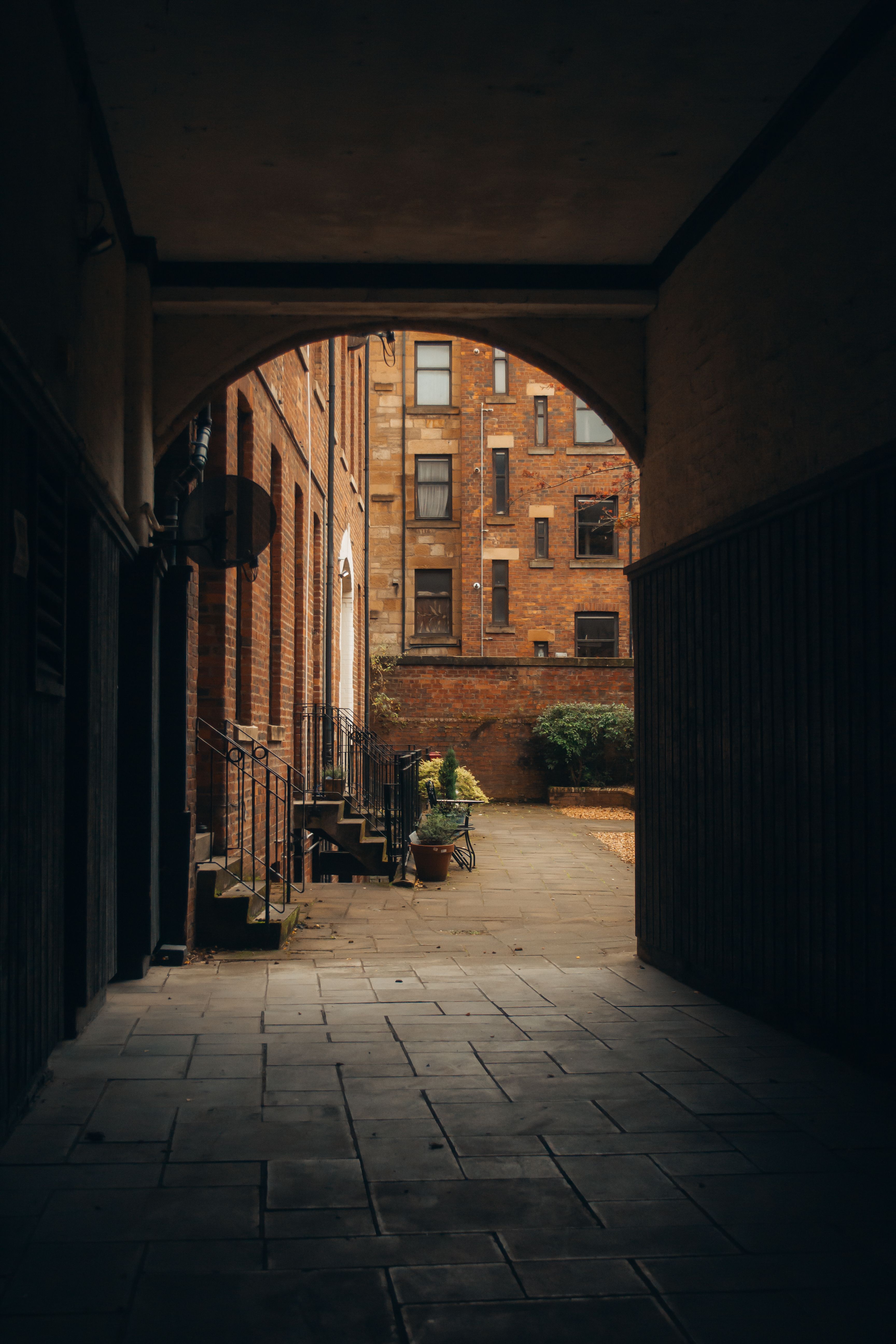 Urban alleyway with vintage brick buildings · Free Stock Photo