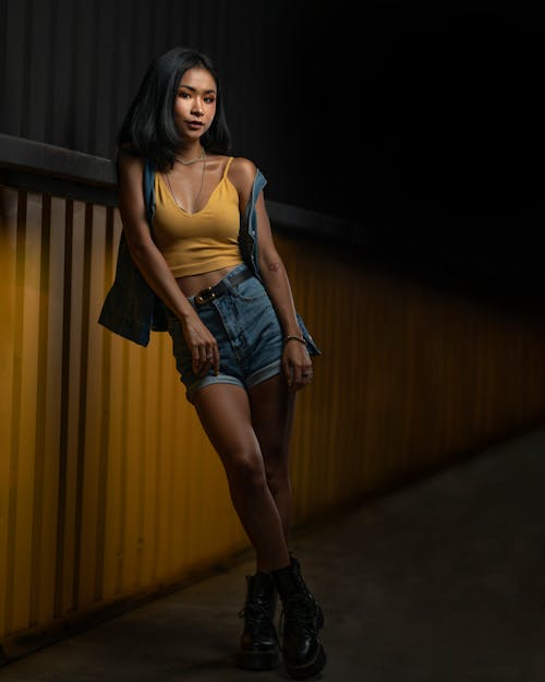 Photo Of Woman Leaning On Yellow Wall