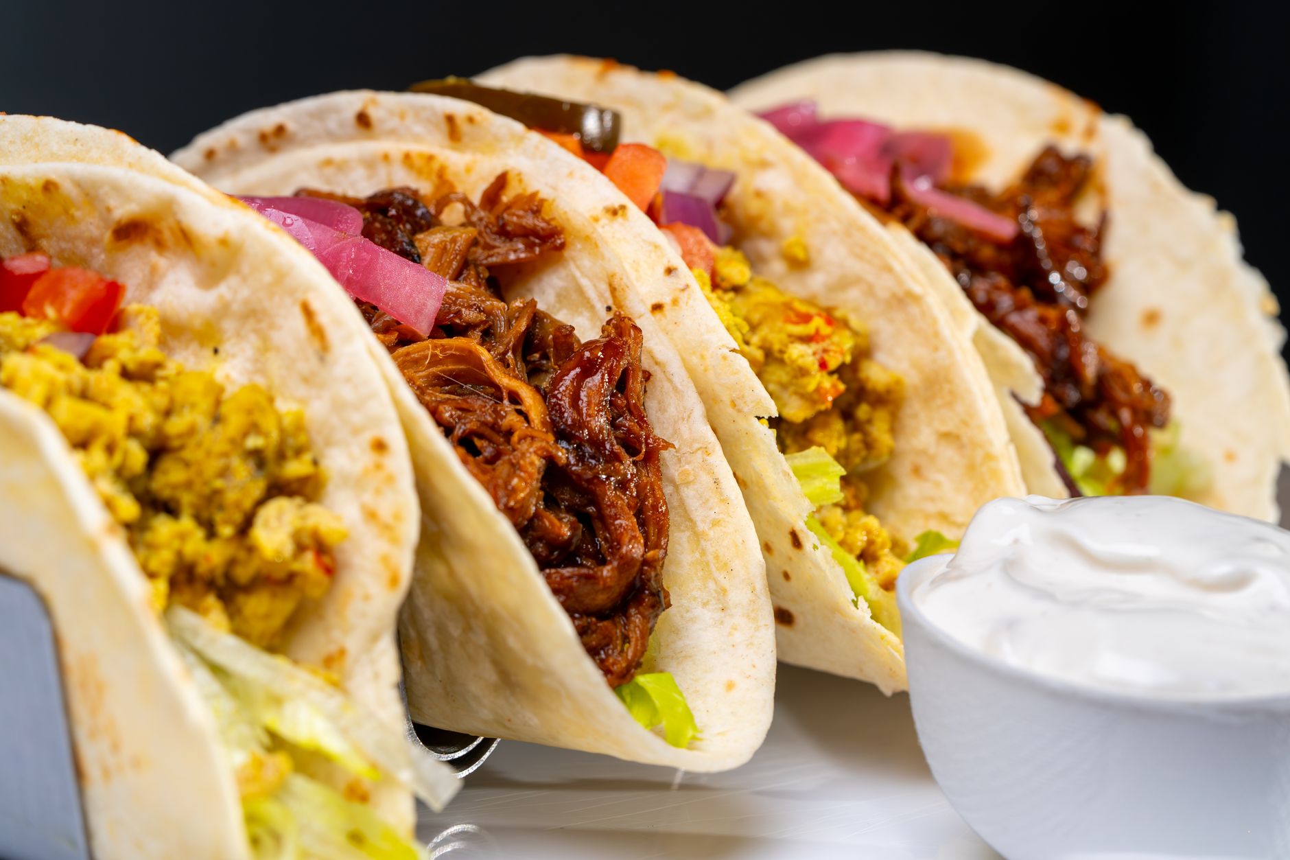 Assembled Cuban pulled pork tacos with colorful slaw