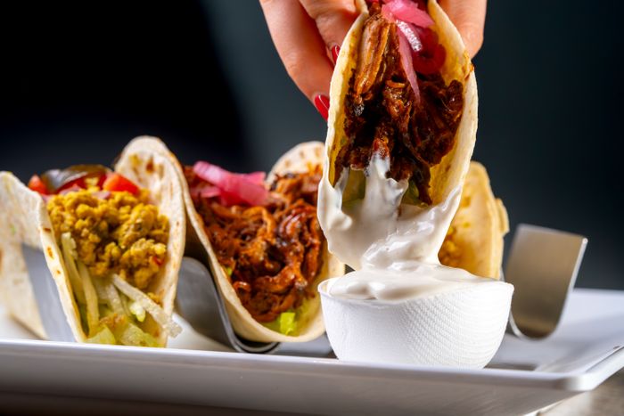 Assorted tacos with pulled pork and sauce