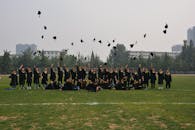 Graduating Class Celebrates with Cap Toss Outdoors