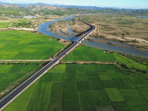 Free Aerial view of green rice fields, river, and bridge in Kon Tum, Vietnam. Stock Photo