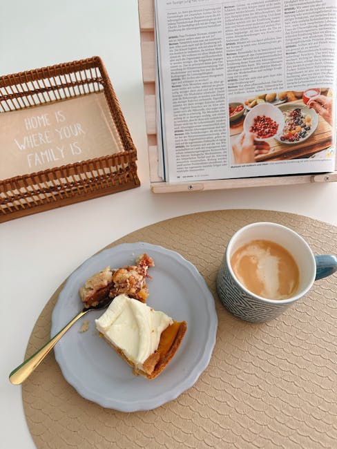 A cozy breakfast scene with a cake slice, coffee, and an open book on a table.