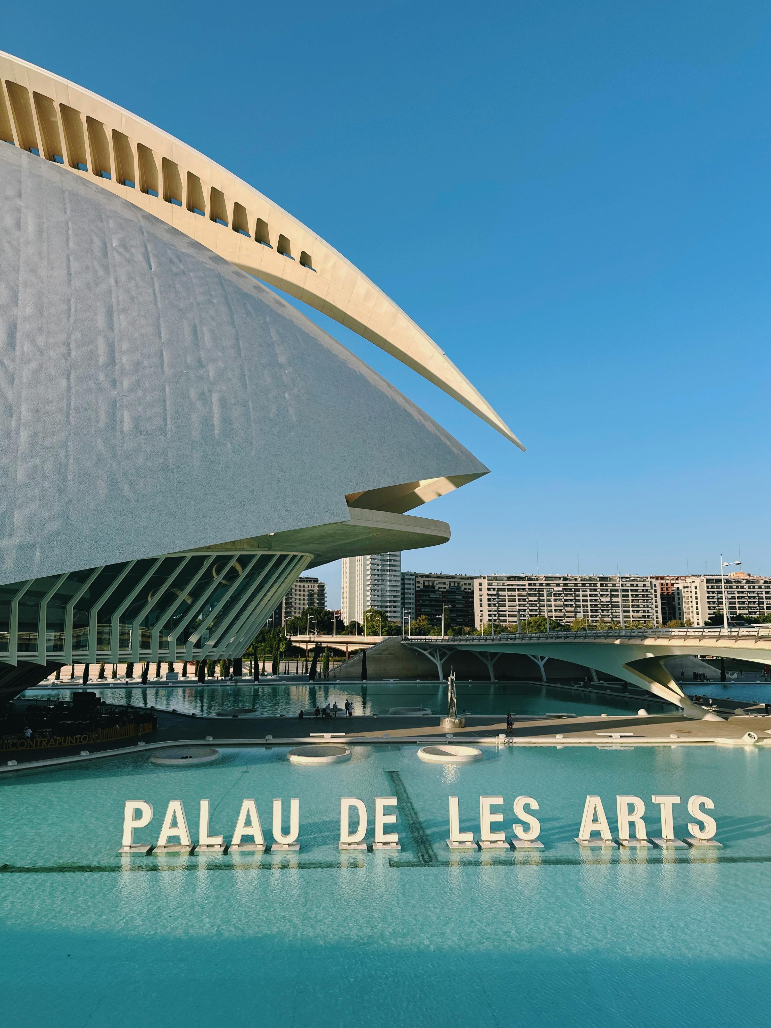 Iconic Palau de les Arts opera house in Valencia with modern architecture under blue sky.