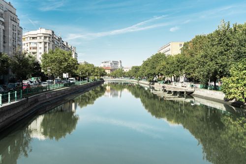 Free Discover the serene beauty of Dâmbovița River in Bucharest on a sunny day. Stock Photo