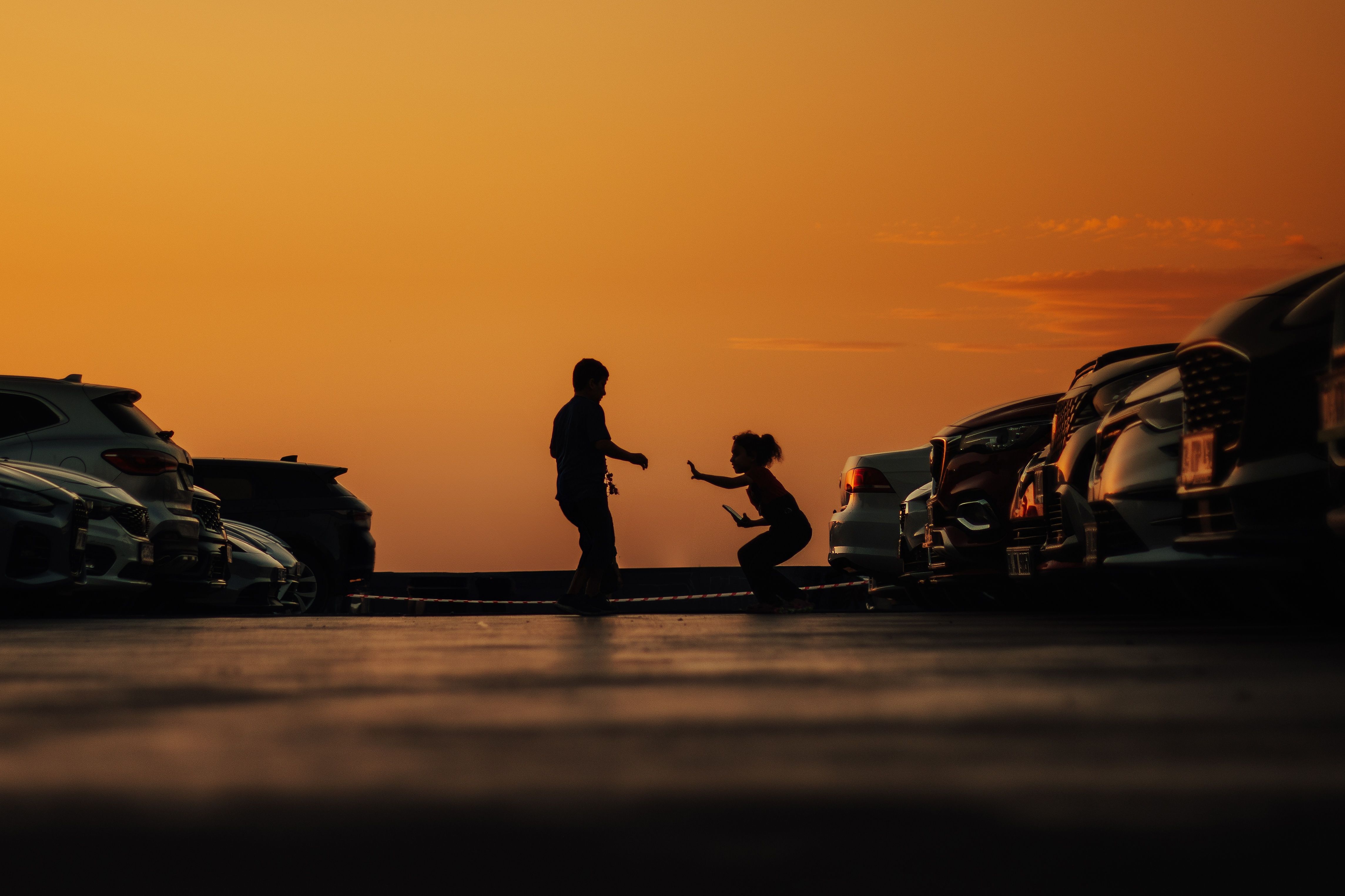 children silhouettes road sunset