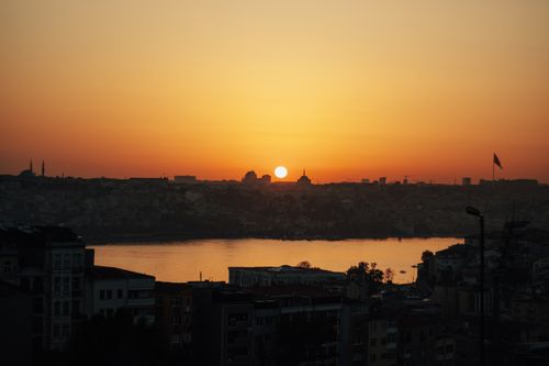 Free Beautiful sunset over İstanbul skyline with silhouettes of buildings and Bosphorus view. Stock Photo