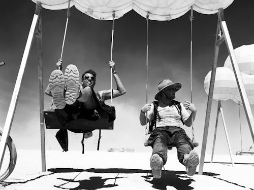 Monochrome Photo Of Men On Swing