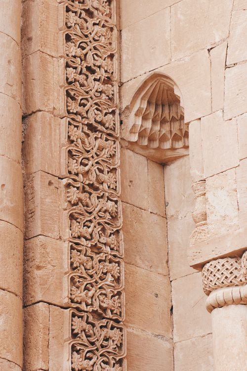 Free Close-up of intricate stone carvings on an ancient architectural structure. Detailed patterns and textures. Stock Photo