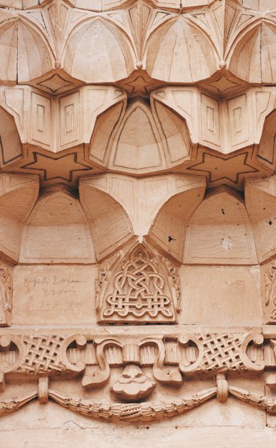 Detailed view of Islamic architectural stonework showcasing geometric and floral patterns.