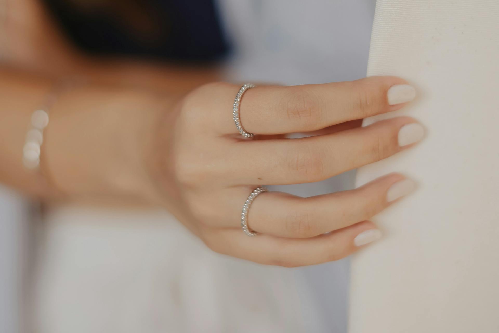 Elegantly manicured hand with diamond rings
