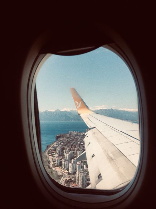 Free View from airplane window of coastline and cityscape below. Stock Photo