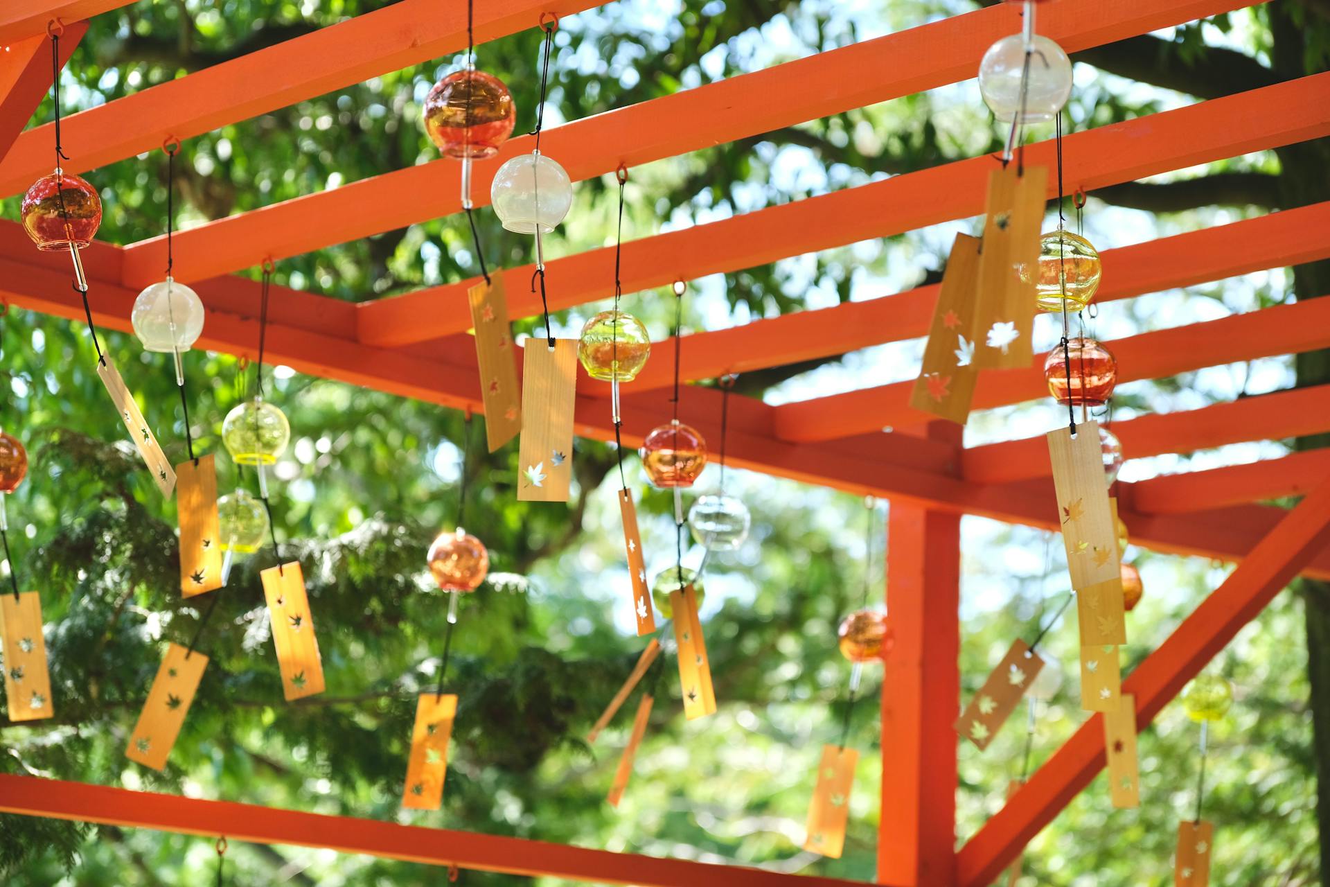 Vibrant Japanese wind chimes hanging in a Tachikawa park, Tokyo.