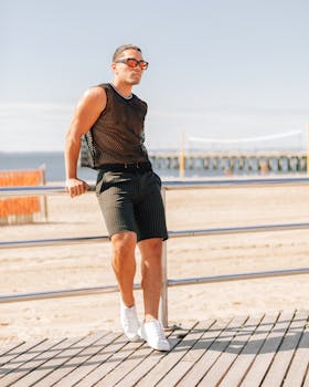 A fashionable man poses stylishly by the beach in New York City.