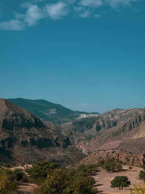 Free Breathtaking view of rugged mountains under a clear blue sky, perfect for travel and nature enthusiasts. Stock Photo