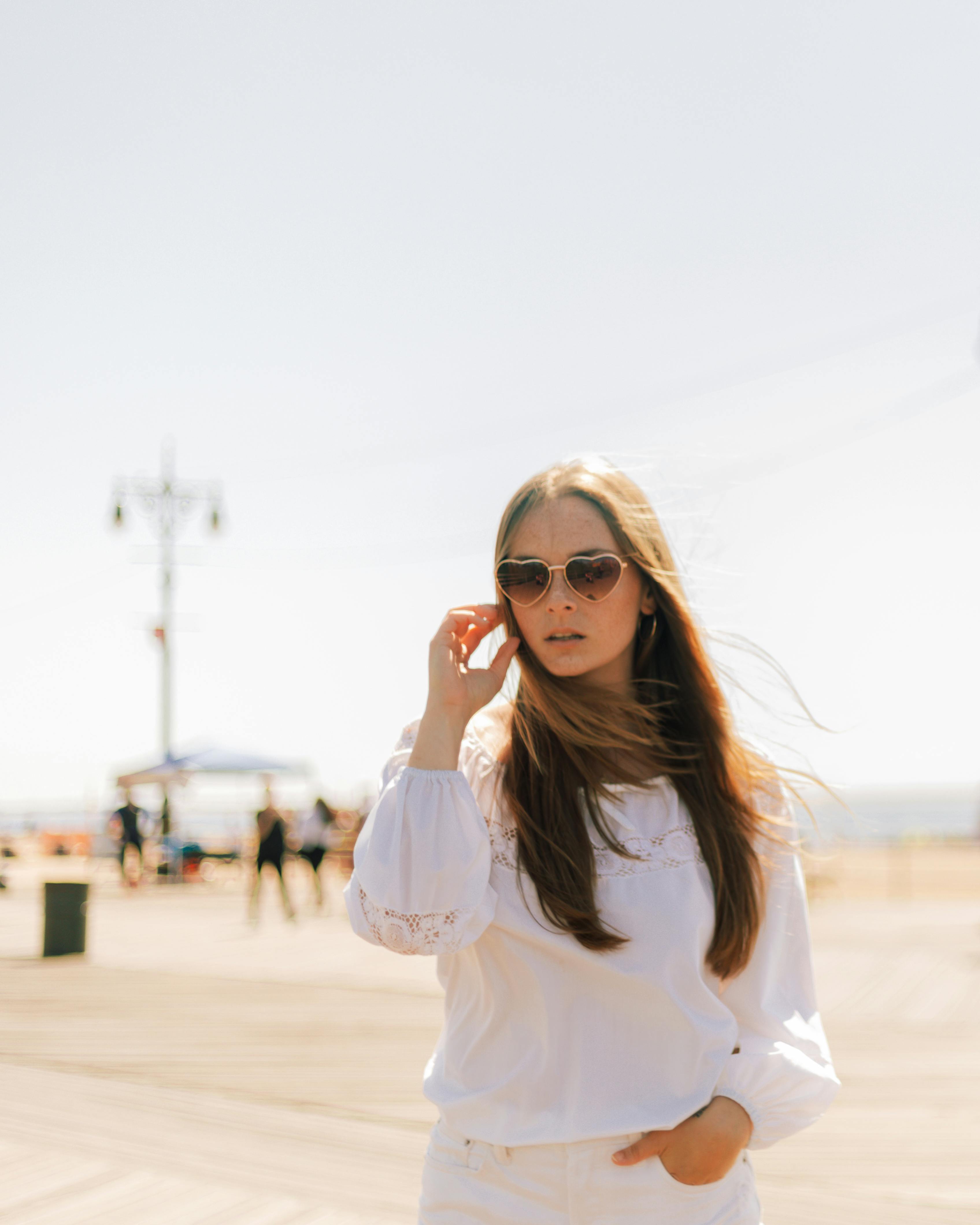 selective focus photo of woman wearing white long sleeved top