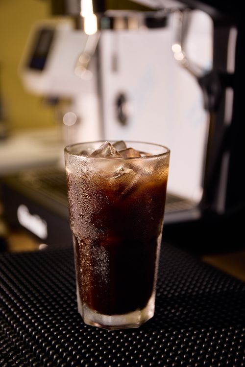 Free Chilled iced coffee in a glass on a café counter, perfect for a refreshing break. Stock Photo