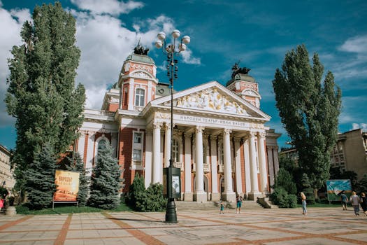 Historic Ivan Vazov National Theater in Sofia on a sunny day.