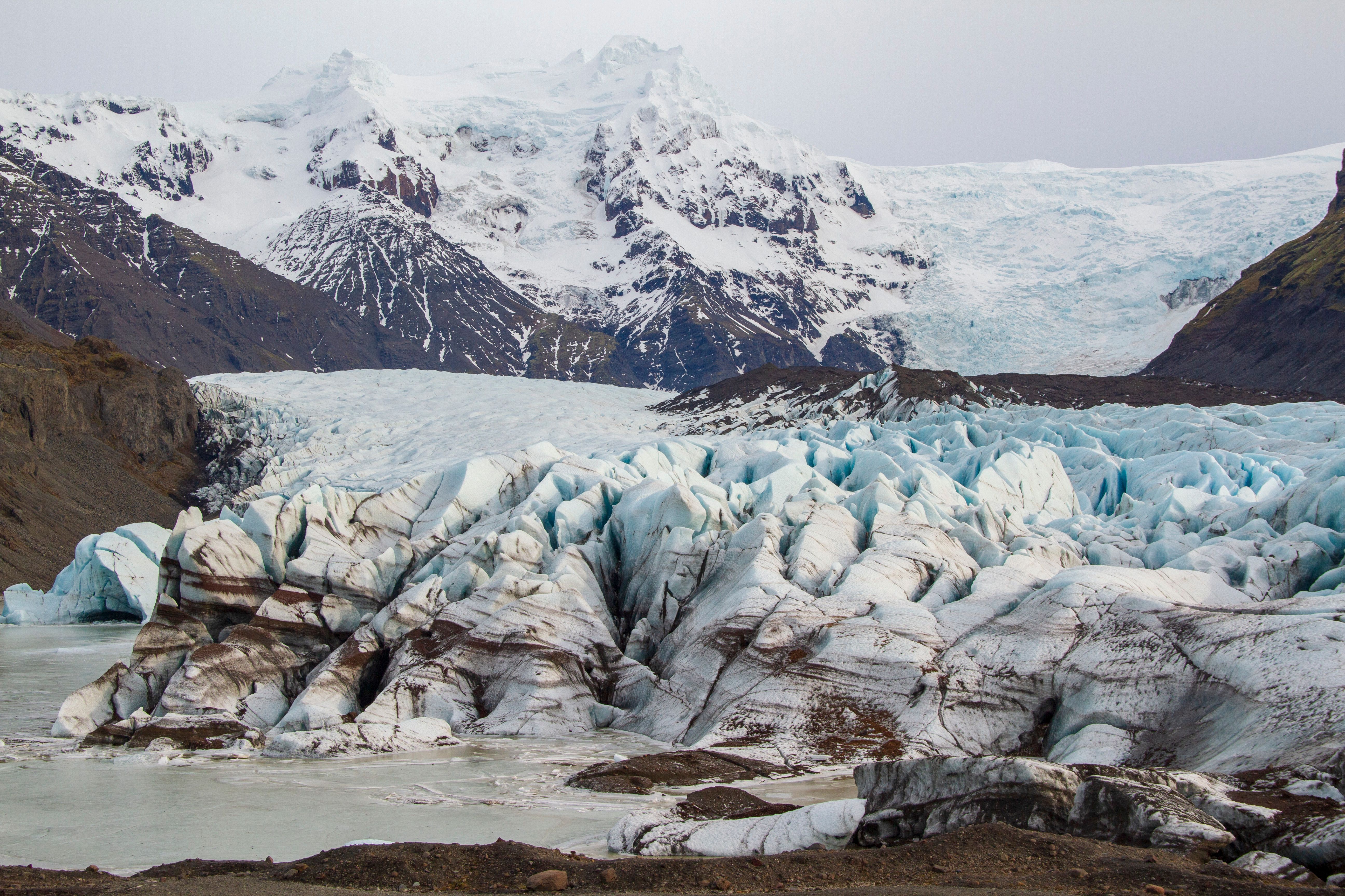 Stunning view of a glacier in Iceland showcasing ice formations and snowy mountains.