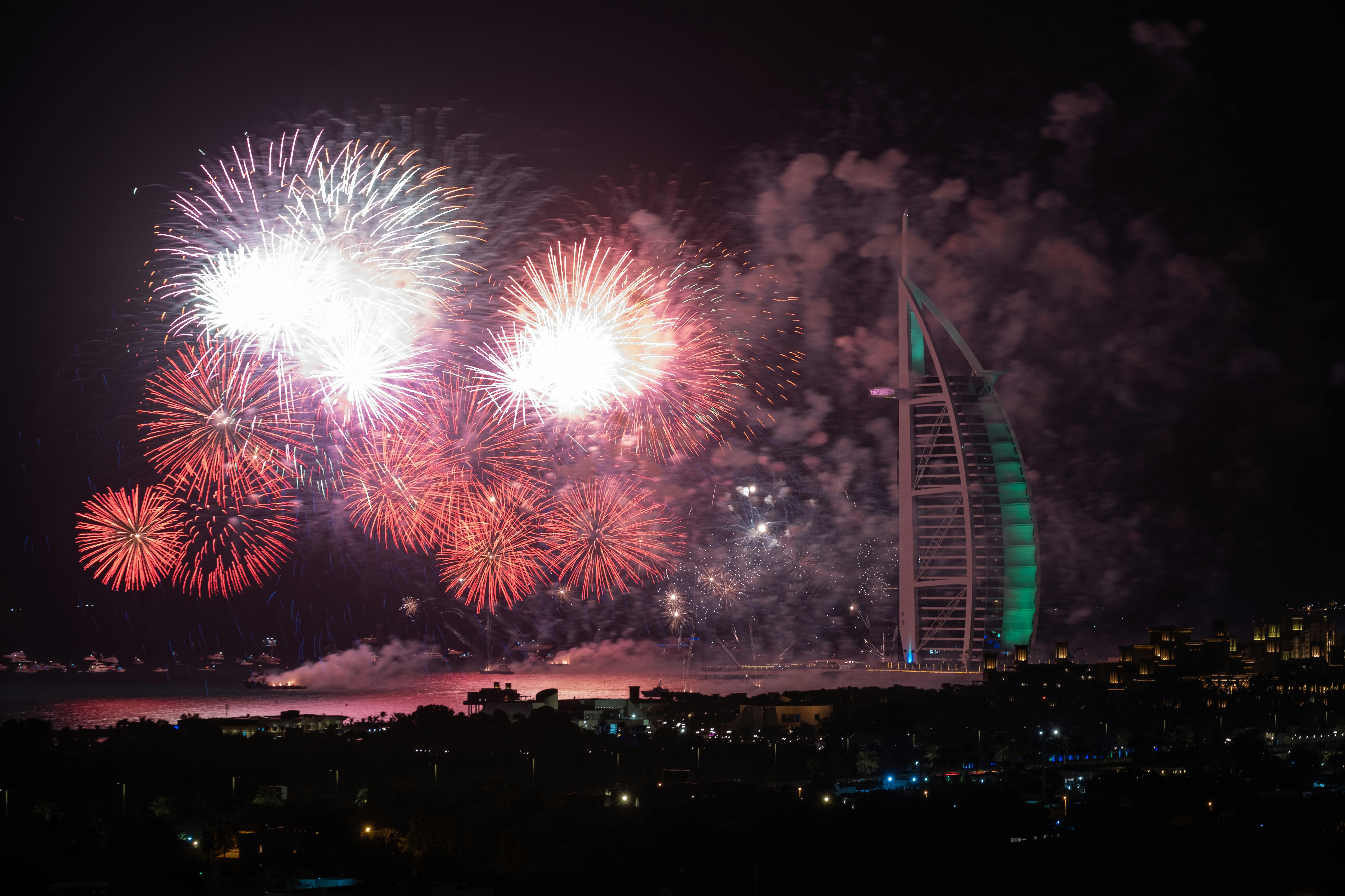 Vibrant fireworks lighting the night sky over Burj Al Arab, Dubai.