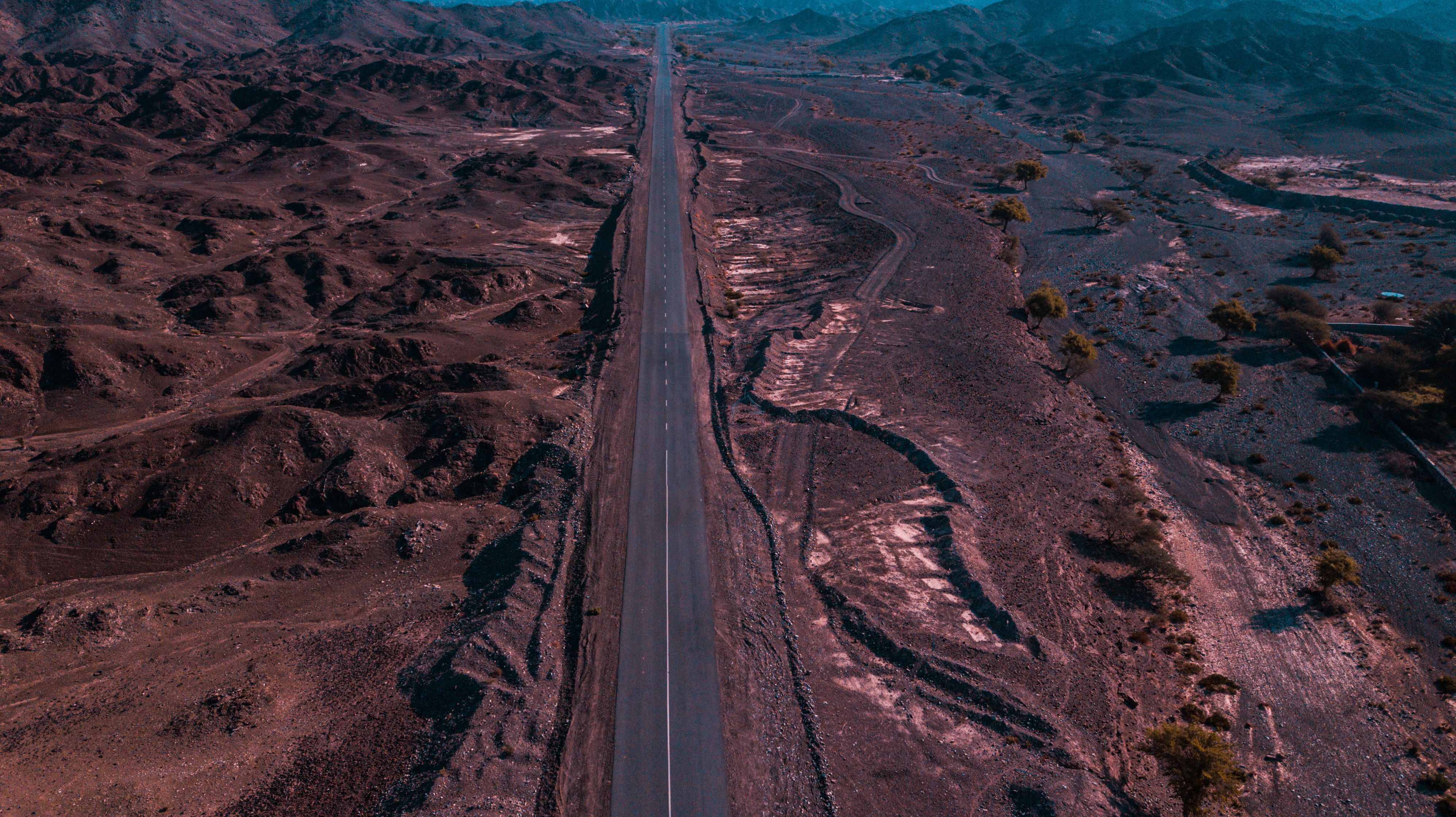 Aerial View of Desert Road through Rocky Landscape · Free Stock Photo