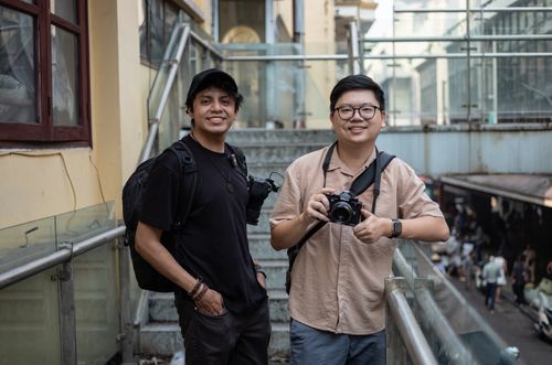 Free Two photographers exploring a bustling city street, capturing urban life moments. Stock Photo