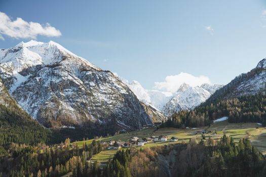 Idyllic alpine village nestled among snow-capped peaks and lush forests.