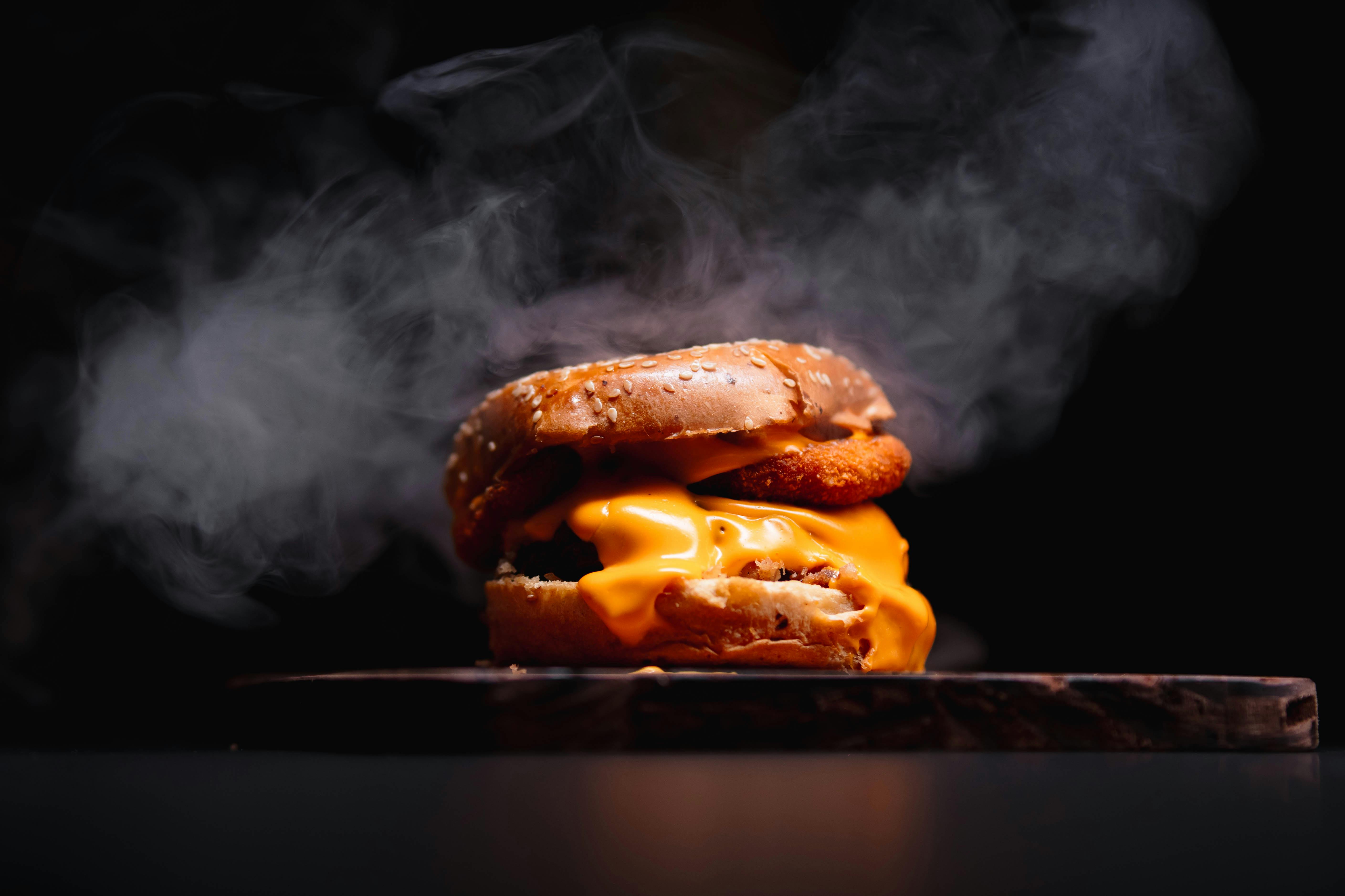 delicious cheeseburger with smoky atmosphere