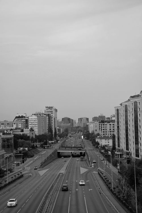 Free Black and white urban cityscape of Almaty, Kazakhstan featuring high-rise buildings and a main road. Stock Photo