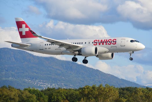 Swiss airplane flying above scenic Geneva with mountainous backdrop.
