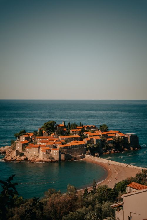 Free An aerial view of the picturesque Sveti Stefan island resort in Montenegro during sunset. Stock Photo