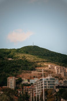 Elegant modern architecture set against a lush green mountain landscape.