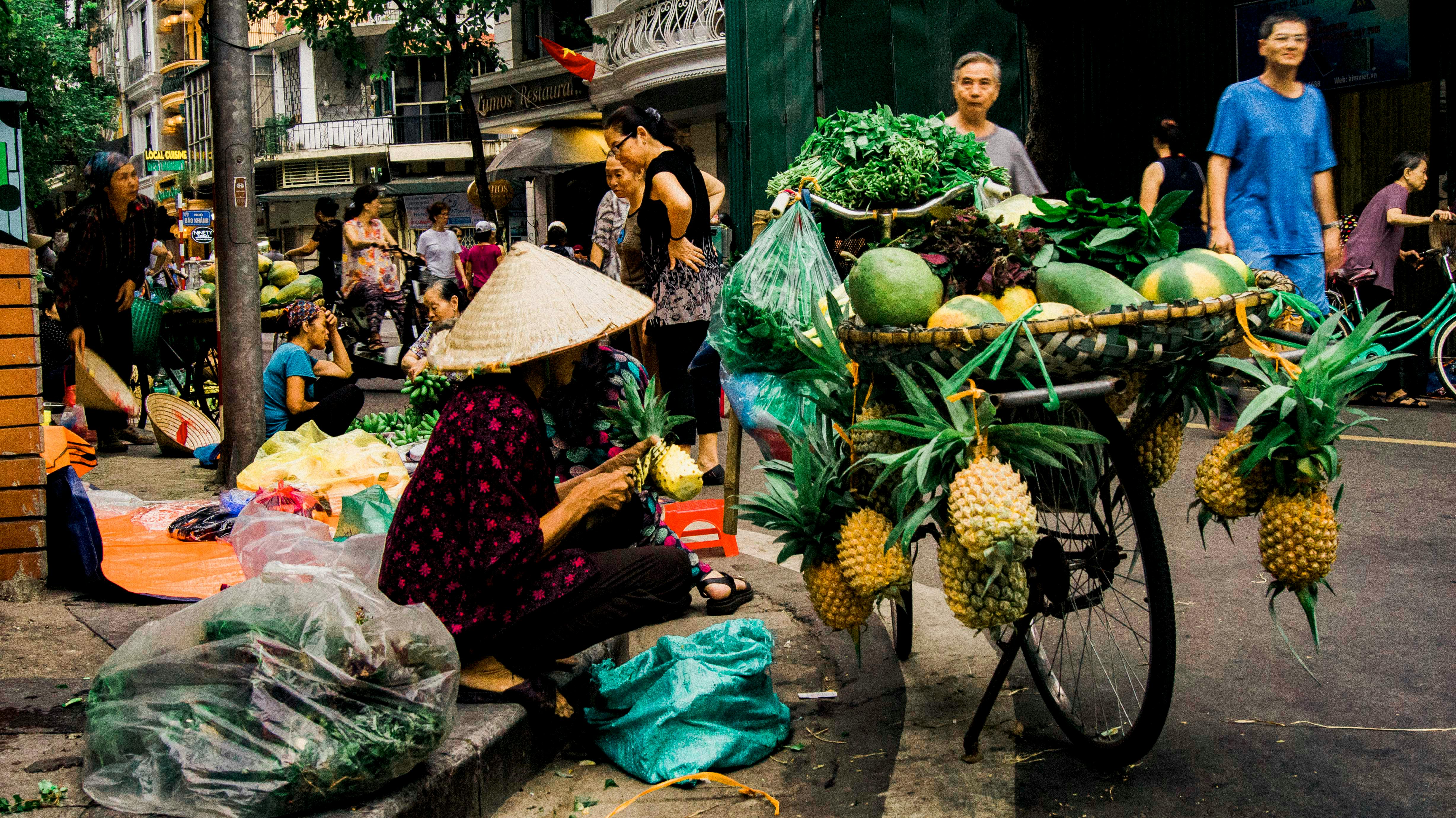 woman sitting beside tray of fruits