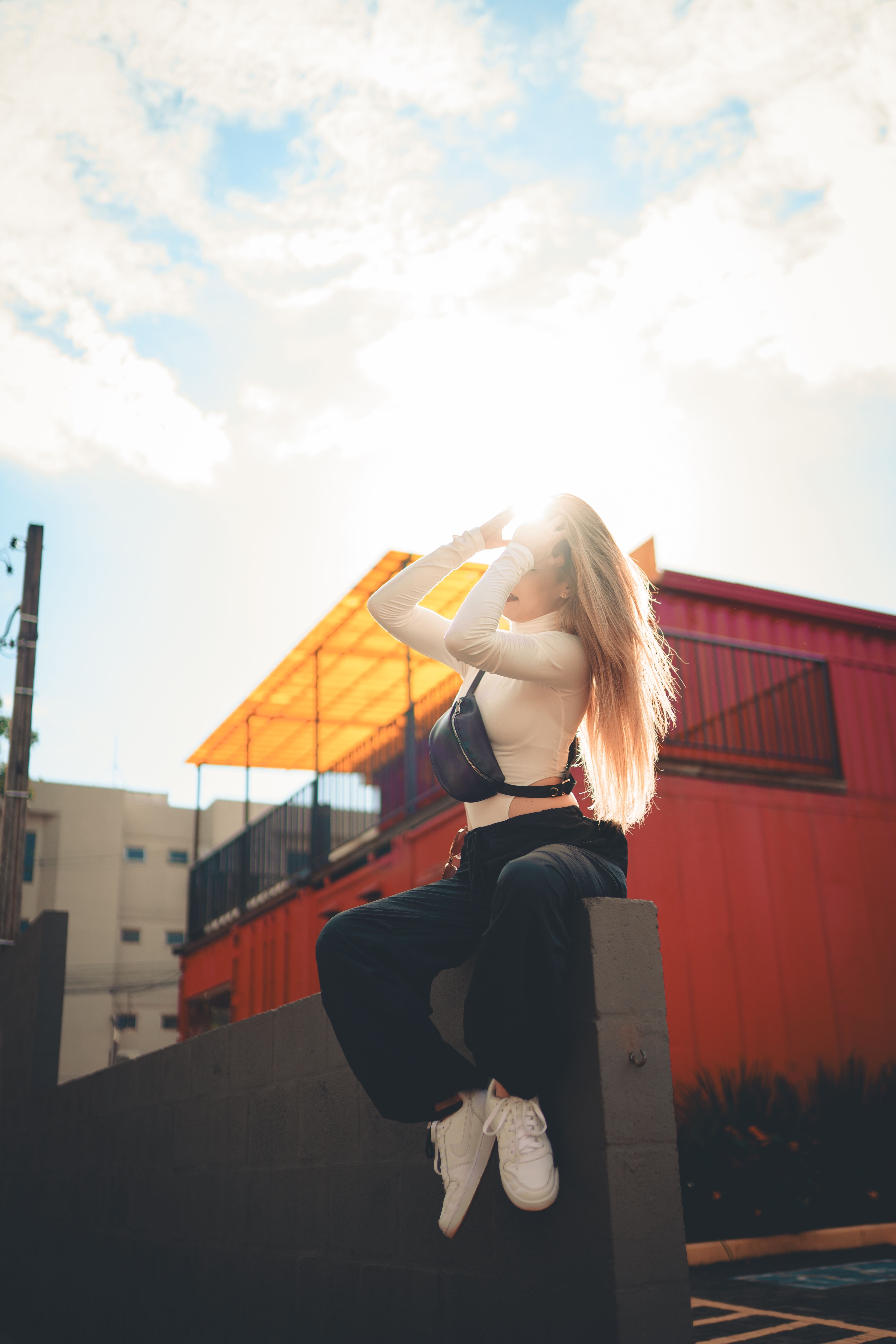 Backlit Urban Portrait of Young Woman Outdoors · Free Stock Photo